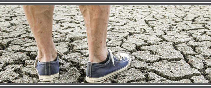 Photo of person standing on cracked ground